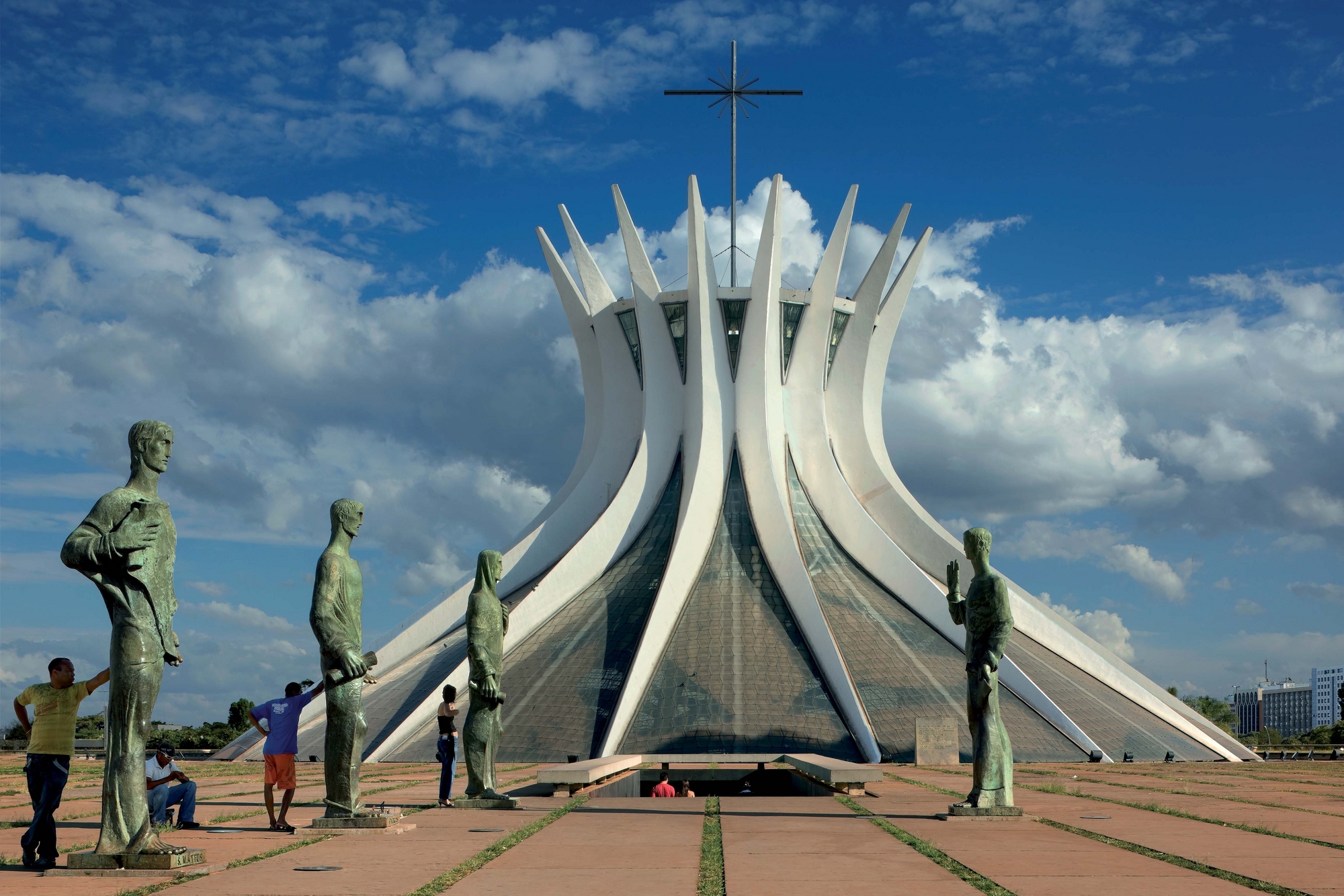 Metropolitan Cathedral of our Lady Apericida: souvenir sellers on duty in the entrance square next to four Dante Croce bronze sculptures, each three metres high, representing the Evangelists