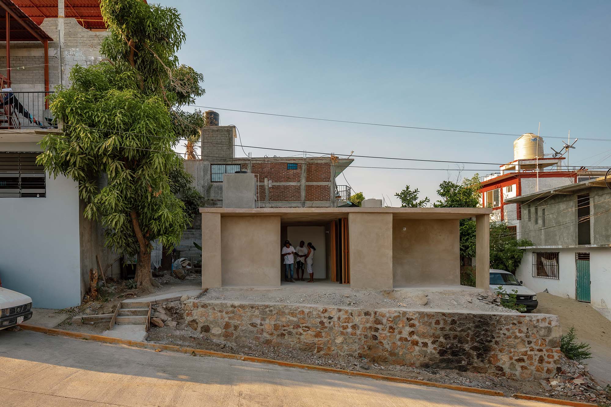 One of the post-hurricane houses by Manuel Cervantes Estudio, in an urban setting, blue sky